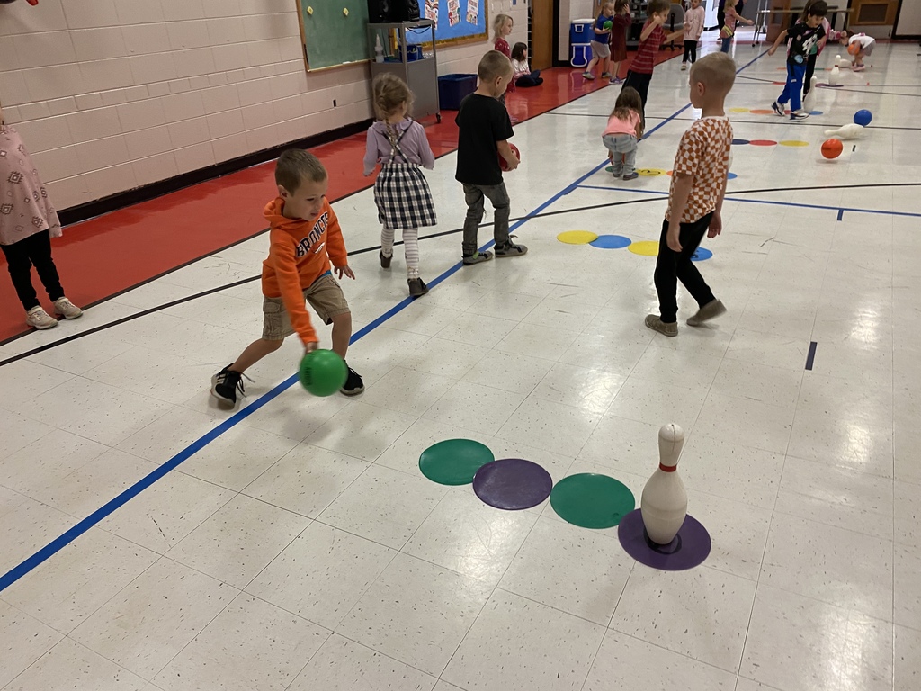 Students rolling a ball