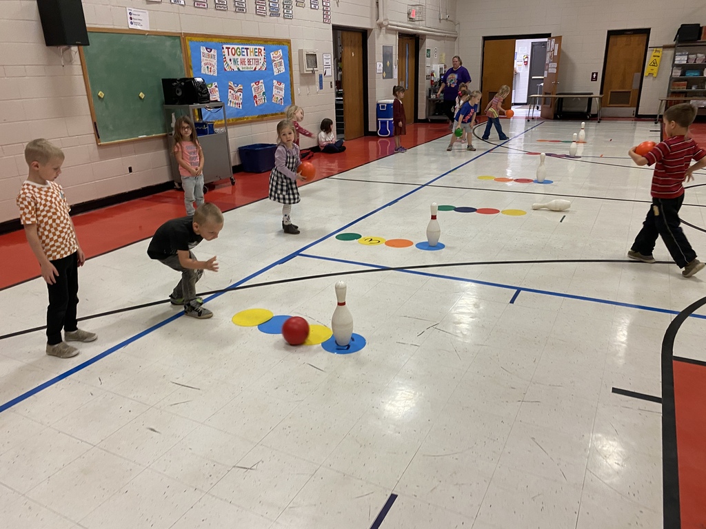 Students rolling a ball