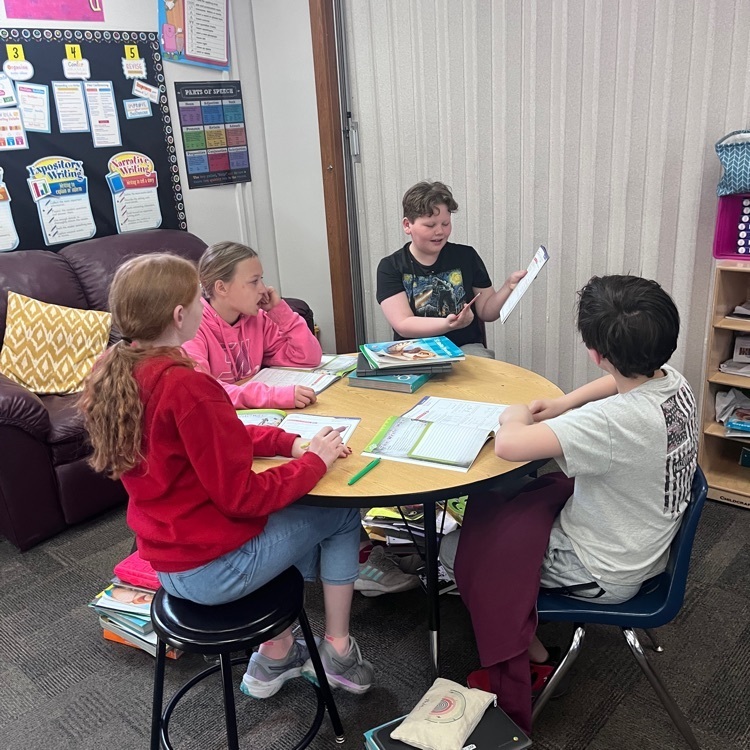 Webster 5th graders collaborating to unlock a problem in math.