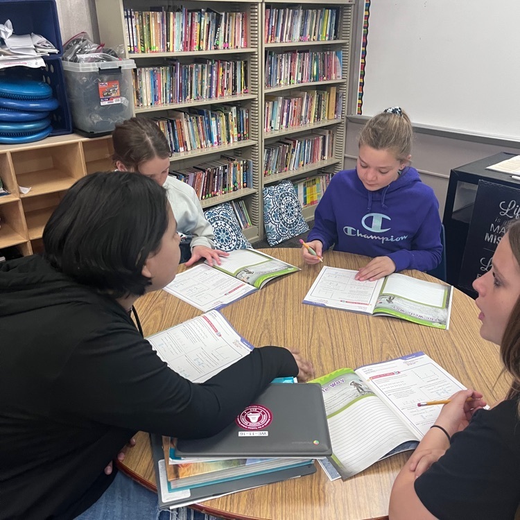 Webster 5th graders collaborating to unlock a problem in math.