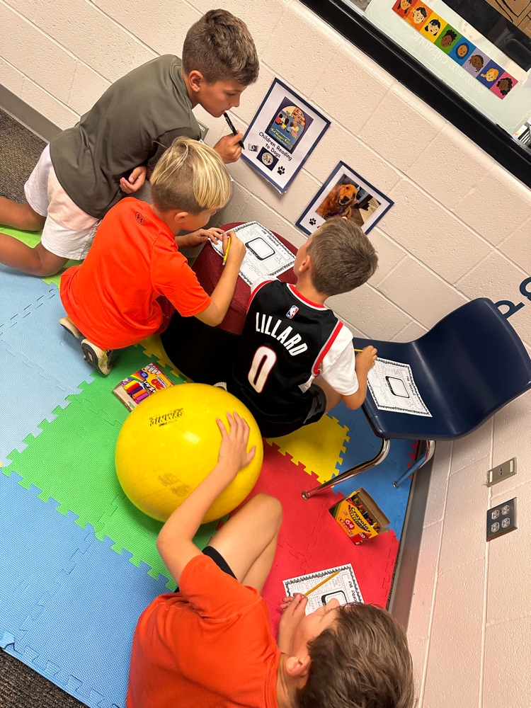 2nd and 5th graders working together
