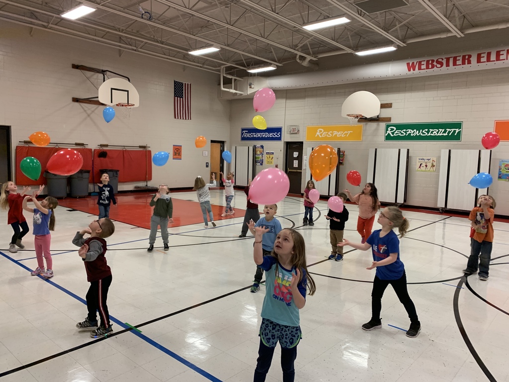 Students hitting balloons.